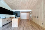 Discover modern elegance in this stunning property featuring a sleek kitchen with black cabinetry and a stylish island.