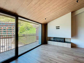 Experience luxury living in this stunning property featuring a modern fireplace and expansive windows.