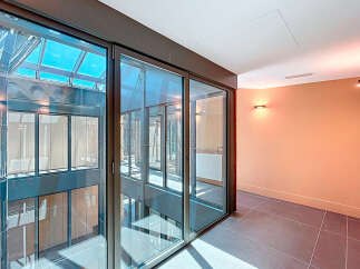 Discover a modern architectural marvel with this stunning property, featuring expansive glass windows that flood the space with natural light.