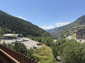 Experience the breathtaking mountain views from this property, nestled in a serene valley.