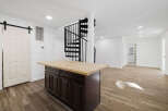 This stunning property features a modern kitchen with a stylish island and a beautiful wooden countertop.