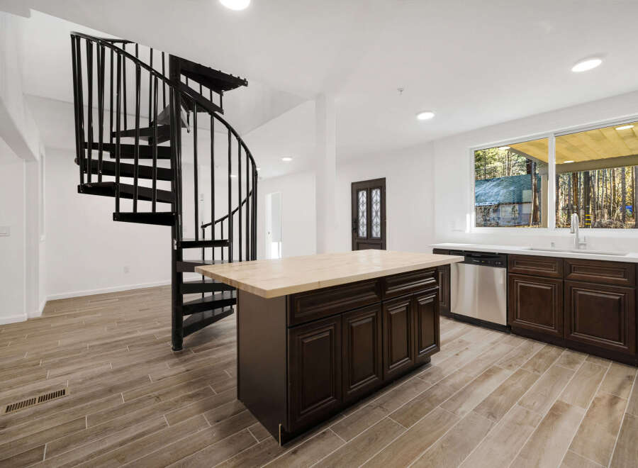This stunning property features a modern kitchen with a large island and stainless steel appliances.
