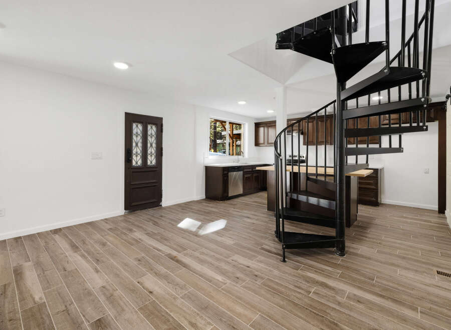 This stunning property boasts a modern interior with a striking spiral staircase as its centerpiece.