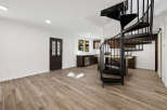 This stunning property boasts a modern interior with a striking spiral staircase as its centerpiece.