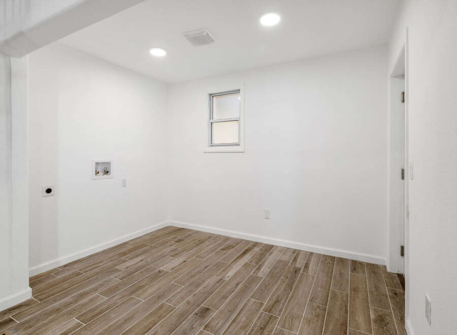 This bright and airy room features a neutral color palette, creating a versatile space for various purposes.