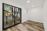 Step into this bright and airy room, featuring a stunning view through a large sliding glass door.
