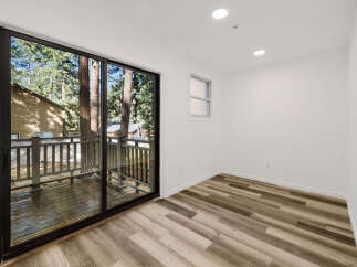 Step into this bright and airy room, featuring a stunning view through a large sliding glass door.