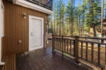 Enjoy the tranquility of this stunning property with a beautiful wooden deck and a charming white door.