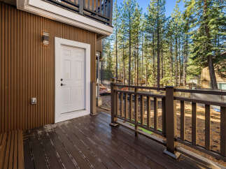Enjoy the tranquility of this stunning property with a beautiful wooden deck and a charming white door.