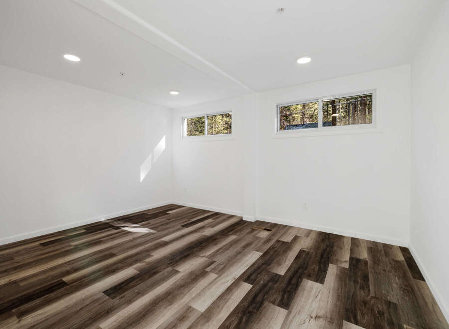 This stunning property boasts a bright and airy interior with pristine white walls and modern recessed lighting.