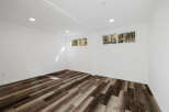 This stunning property boasts a bright and airy interior with pristine white walls and modern recessed lighting.