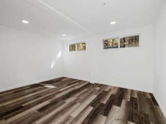 This stunning property boasts a bright and airy interior with pristine white walls and modern recessed lighting.