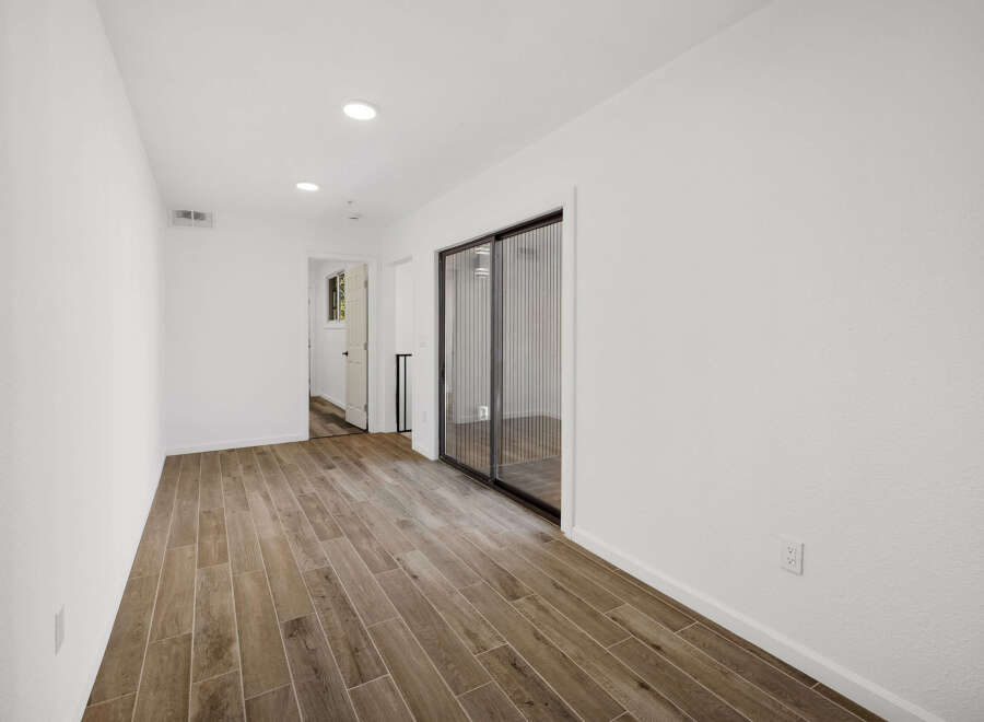 Step into this bright and airy space, featuring beautiful wood-look flooring that extends throughout.