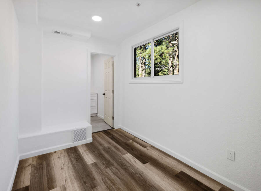 Step into this bright and airy room, featuring beautiful wood-look flooring that adds warmth and style.