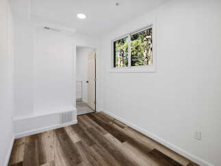 Step into this bright and airy room, featuring beautiful wood-look flooring that adds warmth and style.