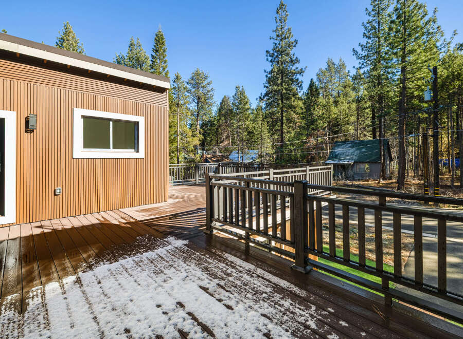 This stunning property boasts a beautiful wooden deck, perfect for enjoying the serene surroundings.