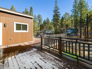 This stunning property boasts a beautiful wooden deck, perfect for enjoying the serene surroundings.