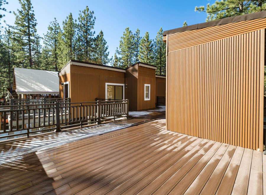 This stunning property boasts a modern design with beautiful wood siding and a spacious deck, perfect for enjoying the outdoors.