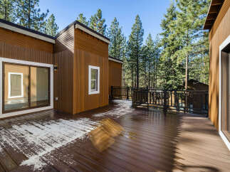 This stunning property boasts a beautiful wooden deck, perfect for enjoying the serene surroundings.
