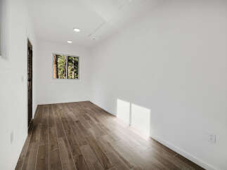Step into this bright and airy space, featuring beautiful wood-look tile flooring that adds warmth and character.