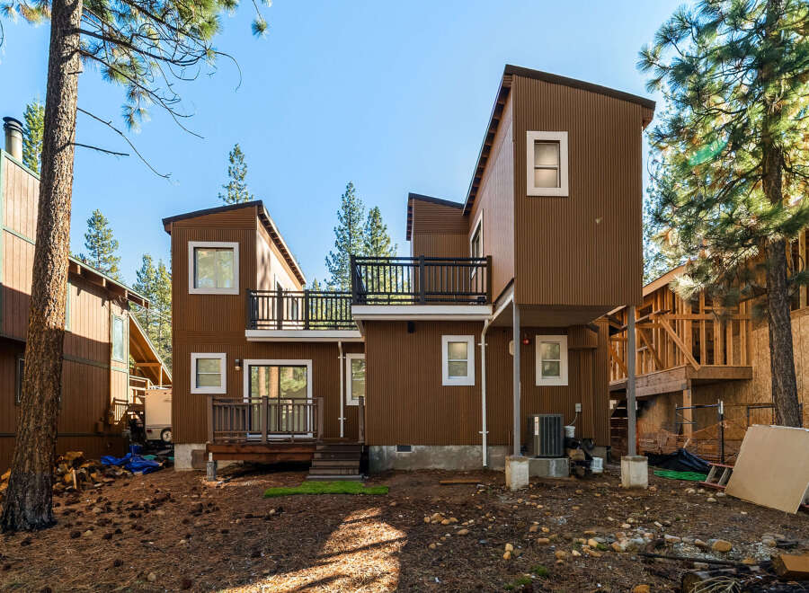 This stunning property boasts a modern design with a unique architectural style, featuring a beautiful brown exterior and multiple levels.