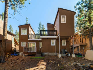 This stunning property boasts a modern design with a unique architectural style, featuring a beautiful brown exterior and multiple levels.