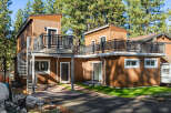 This stunning property features a modern design with a unique spiral staircase and multiple balconies, perfect for enjoying the surrounding natural beauty.