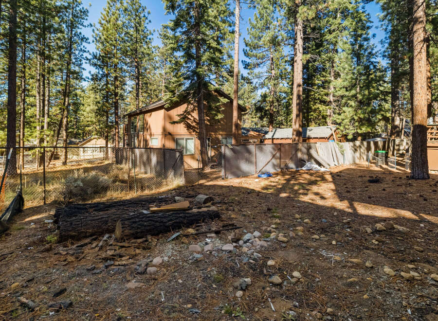 Nestled amidst towering trees, this property offers a serene escape.