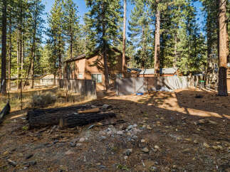 Nestled amidst towering trees, this property offers a serene escape.