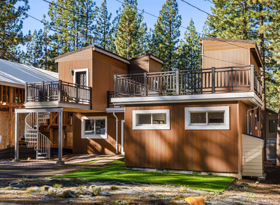 This stunning modern home boasts a unique design with multiple levels and a beautiful spiral staircase.