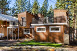 This stunning modern home boasts a unique design with multiple levels and a beautiful spiral staircase.