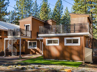 This stunning modern home boasts a unique design with multiple levels and a beautiful spiral staircase.