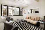 This stunning living room boasts a modern design with a sleek black and white striped rug, creating a bold statement.