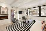 This stunning living space boasts a modern design with a cozy fireplace, perfect for relaxing evenings.