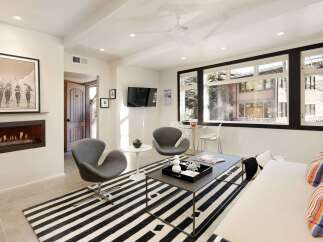 This stunning living space boasts a modern design with a cozy fireplace, perfect for relaxing evenings.