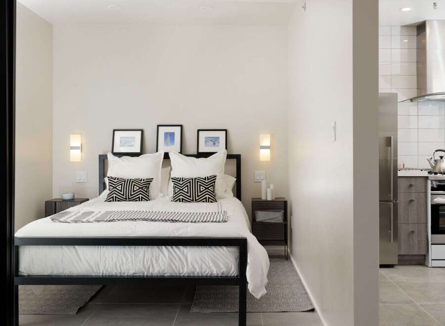This modern bedroom offers a serene retreat with its minimalist design and neutral color palette.
