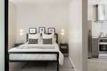 This modern bedroom offers a serene retreat with its minimalist design and neutral color palette.