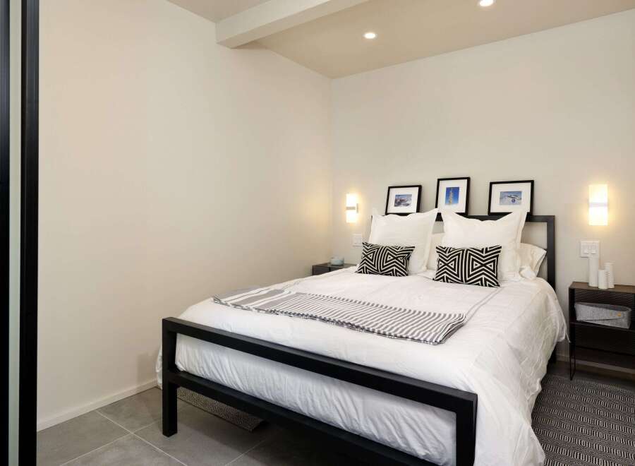 This modern bedroom offers a serene retreat with its minimalist design and neutral color palette.