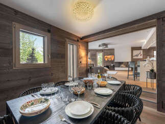 Step into luxury with this stunning dining room, featuring a rustic wooden aesthetic and elegant decor.
