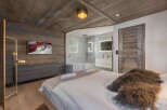 Experience luxury living in this stunning bedroom featuring a modern design and high-end finishes.