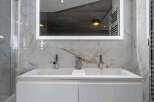 This luxurious bathroom features a modern double vanity with sleek chrome fixtures.