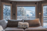 Experience the ultimate winter escape in this stunning property! Enjoy breathtaking views of snow-covered mountains and lush forests from the comfort of your cozy living room.