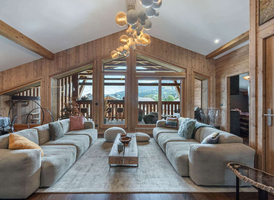 Experience luxury living in this stunning property, featuring a spacious living room with a cozy fireplace and large windows.