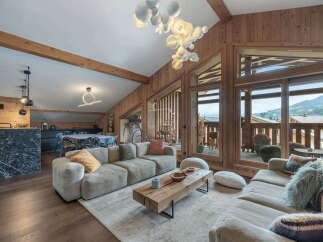 Experience luxury living in this stunning property, featuring a spacious living area with a cozy sectional sofa and a modern coffee table.
