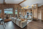 Experience luxury living in this stunning property, featuring a spacious living area with a cozy sofa and a modern design.
