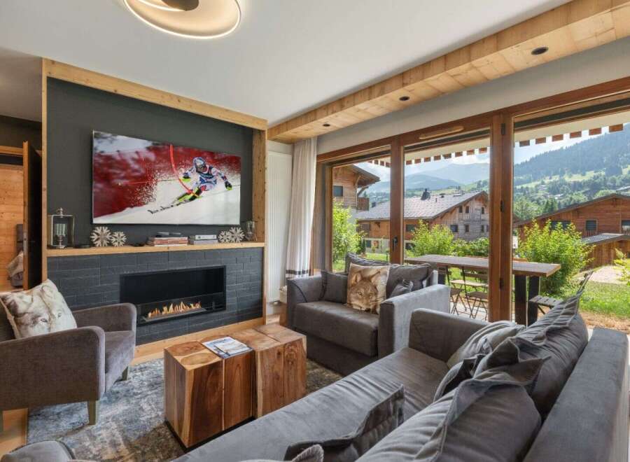 Experience luxury living in this stunning property, featuring a cozy fireplace and a large flat-screen TV perfect for entertainment.