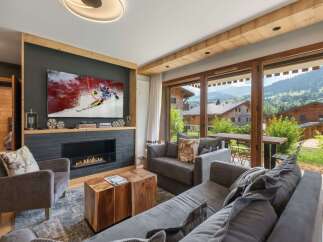 Experience luxury living in this stunning property, featuring a cozy fireplace and a large flat-screen TV perfect for entertainment.