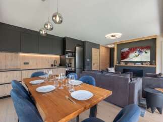 Experience luxury living in this stunning property, featuring a modern kitchen with sleek cabinetry and a spacious dining area perfect for entertaining.
