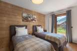 This charming bedroom features two twin beds, perfect for guests or family.