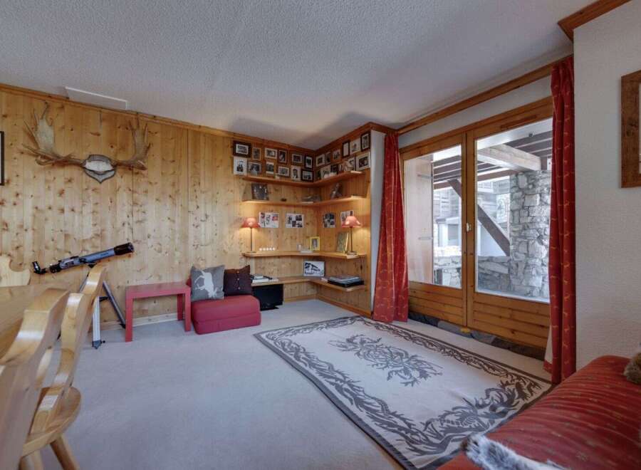 Step into a cozy living space with rustic charm, featuring wood-paneled walls and a welcoming atmosphere.